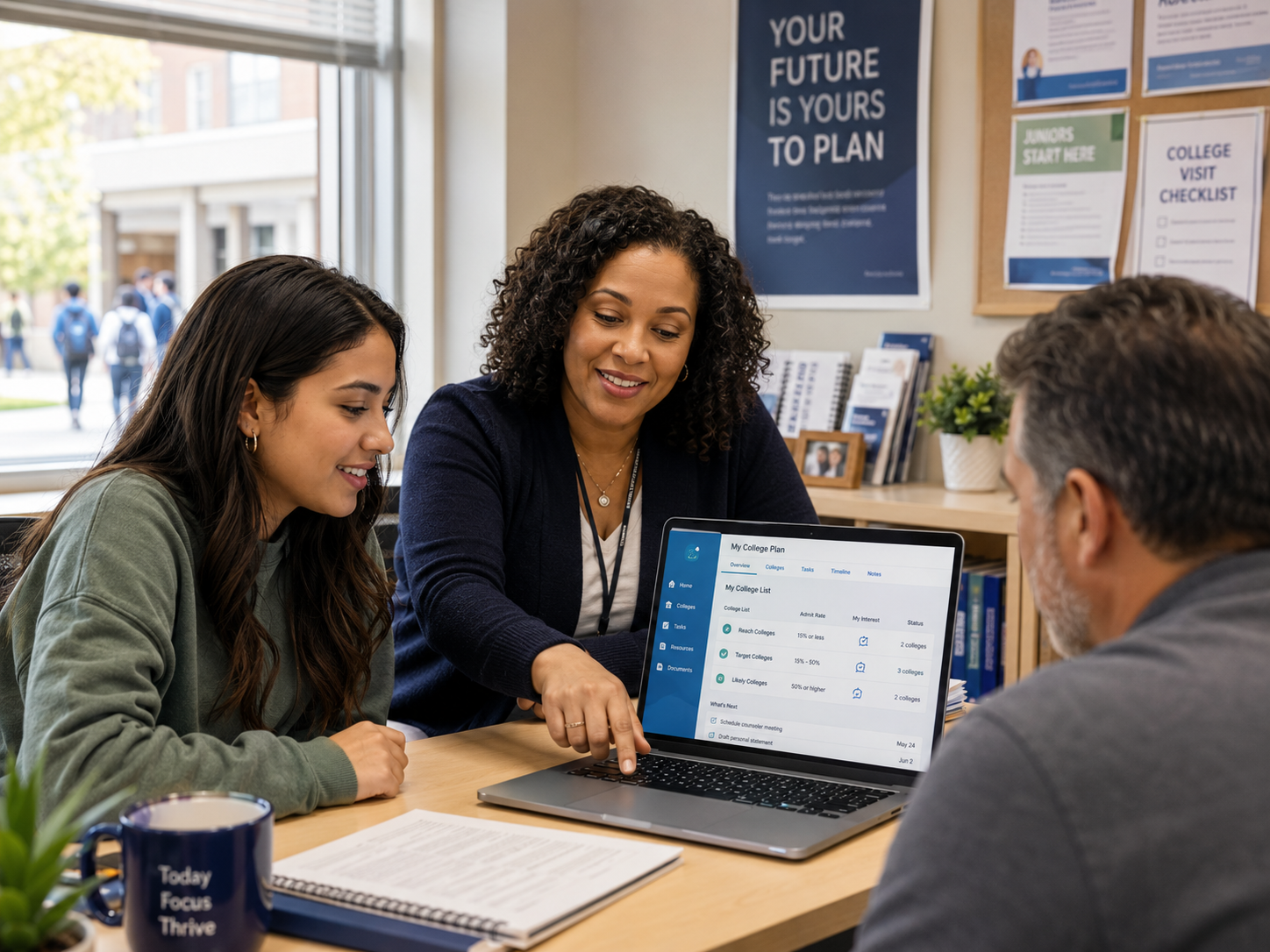 High school counselor reviewing a college planning screen with a student and parent