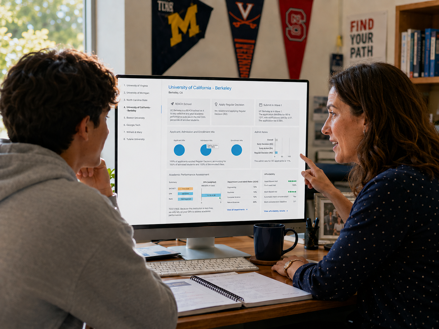Counselor and student reviewing a detailed school profile on a desktop monitor